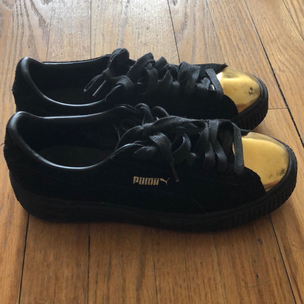 Puma sneakers. Black and gold . Used. Size 8W.